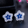 Detailed shot of silver flower earrings with blue teardrop and white square zirconias - Blue