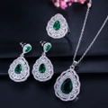 Macro view of pear-cut emerald zircon necklace set with double halo silver setting - Green
