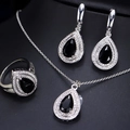 Detailed view of silver necklace earrings and ring set with black pear-shaped stones - Black
