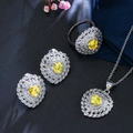 Macro shot of silver heart jewelry set with yellow zircon stones and petal-like details - US 7 / Yellow