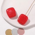 Macro view of red translucent resin square charm with white marble texture for jewelry DIY - Red