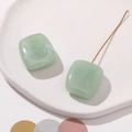 Detail of light green marbled resin square pendant with a slim golden metal connector - Light Green