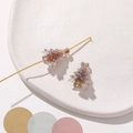 Macro shot of two gradient rainbow Christmas tree resin beads on a white ceramic plate - 1 Piece / Brown