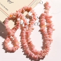 Macro view of irregular pink opal stone beads for DIY jewelry making on art book - Pink Opal Chips