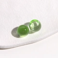 Macro shot of 14mm light green translucent jelly resin round cabochons on white tray - 1 Piece / Green