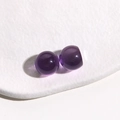 Macro detail of 14mm translucent purple resin round beads with glossy finish on display - 1 Piece / Purple