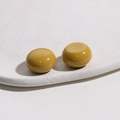 Detailed macro view of mustard yellow resin cabochon beads for DIY jewelry accessories - Khaki/Earth Yellow