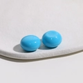 Macro shot of glossy 18mm sky blue round resin cabochons on white stone texture base - 1 Piece / Sky Blue