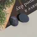 Detailed view of dark gray glitter oval resin charms with faceted and smooth surfaces - 1 Piece / Gray