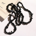 Macro view of natural irregular black stone chips necklace with polished obsidian textures - Black Agate Chips