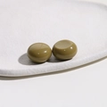 Close-up of olive green resin dome cabochons for DIY jewelry and phone case crafts - Olive Green