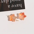 Macro view of matte gradient star beads in peach pink with gold metal pin detail - 1 Piece/Pack / Orange Red