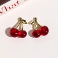 Detailed view of red translucent resin cherry charms with polished golden metal leaves - Dark Red Linked Style