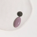 Close-up of glossy Morandi-colored resin oval and round flatback charms for DIY jewelry - Green Half Ball + Purple Oval