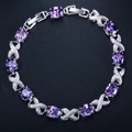 Detailed close-up of a silver bracelet with oval purple zircons and X-shaped diamond links - Purple