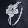 Macro view of silver floral open bangle with sparkling cubic zirconia pavé stones - Platinum