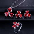 Macro shot of 925 silver jewelry set featuring red heart-shaped zircon flower motifs - Size 6 / Red