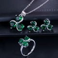 Macro detail of silver clover jewelry set featuring deep green zircon stones - Size 6 / Green