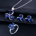 Detail of silver clover jewelry set with blue heart gemstones and crystal accents - Sapphire Blue