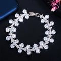 Macro shot of silver finish bracelet with pavé-set round cubic zirconia and folding clasp - White