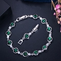 Elegant silver bracelet with oval green gemstones and AAA cubic zirconia on dark texture - Green