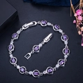Close-up of silver-tone link bracelet with purple oval gemstones and white AAA zirconias - Purple
