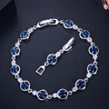 Detailed shot of a silver zircon bracelet with navy blue stones and folding clasp - Blue
