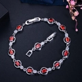 Silver bracelet with oval red zircons and white crystals, includes an extra clasp extender - Red