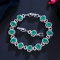 Macro shot of silver-plated oval green gem bracelet with micro-pave zirconia details - Malay Jade