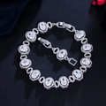 Detailed macro view of oval-cut zircon bracelet with micro-pave setting on black surface - White