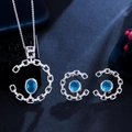Verzilverde sieradenset met ovale blauwe edelstenen en glanzende micro-pavé kristallen - Aqua