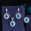 Elegant jewelry set with oval blue gemstones and zircon halo including necklace ring and earrings - Aqua
