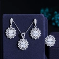 Detailed macro shot of sunburst ruby jewelry set on velvet display including ring and earrings - US 6 / White