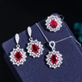 Detailed view of red ruby jewelry set with halo zirconia on dark velvet background - US 6 / Rose Red