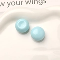 Close-up of light blue macaron resin button accessories on a decorative white plate - Light Blue