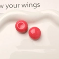 Macro shot of bright pink resin dome studs with glossy finish for DIY jewelry crafting - Rose Red
