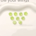 Macro view of nine 10mm aurora green resin camellia flowers on a white ceramic tray - 10mm (1 Piece) / Green