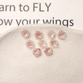 Macro shot of 9 translucent rose charms with gold foil inside for DIY nail art and crafts - 8mm / Red
