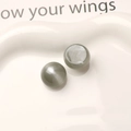 Macro shot of 16mm grey resin cat eye beads with starry shimmer for DIY jewelry making - Gray