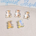 Macro shot of 5 mini iridescent bear nail charms with shimmering AB aurora resin finish - 1 Piece / Transparent Aurora Color