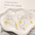 Close-up of beaded bow pendant with long colorful tassels on a white cloud tray - White Pink Yellow Teardrop Style