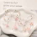 Detailed view of handmade beaded bow pendants with pink butterfly and floral charms - Pink Flower Style
