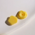Macro detail of small yellow resin flower beads with back holes for DIY jewelry making - Small Yellow