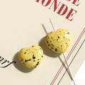 Macro view of heart-shaped yellow turquoise beads with black splatter for DIY jewelry - 1 Piece / Yellow