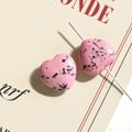 Detailed macro view of heart-shaped pink resin beads with ink spots for DIY jewelry - Pink