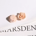 Macro detail of cream pink ceramic rose charms with layered petals for DIY accessories - Orange