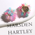 Macro detail of colorful sequin flower earrings with gold-plated metal base plates - Creamy Green Glass Bead Style