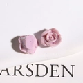 Macro view of pearlescent pink-purple resin rose flatback charms for DIY jewelry making - Purple