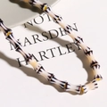 Close-up of handmade millefiori glass bamboo style beads with yellow cord detail - 1 Piece/Pack / Yellow Black White