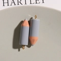 Macro shot of 3D resin pencil pendants in gray and pink for DIY jewelry making - Gray